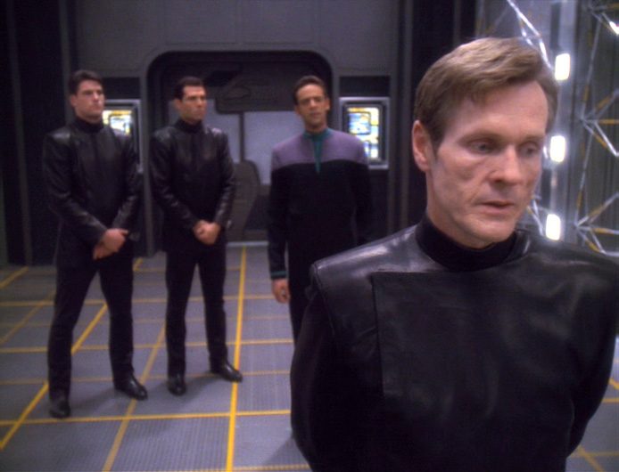 William Sadler as Sloan (right), Deputy Director of Section 31, stands on a holodeck with Julian Bashir and two S31 agents.