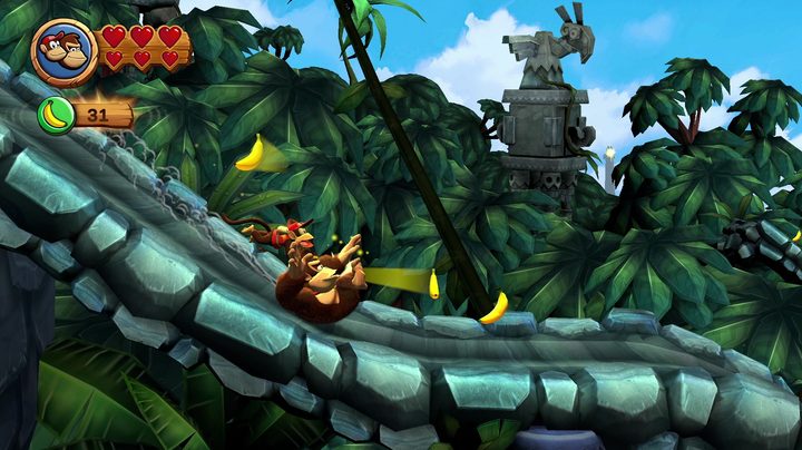 Donkey and Diddy Kong slide down a level in Donkey Kong Country Returns HD.