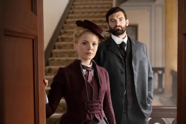 A man and a woman look ahead in Miss Scarlet and the Duke.