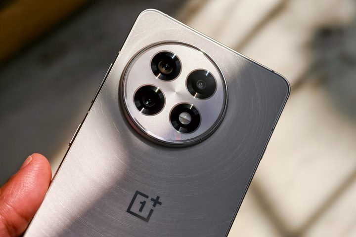 Camera module on the OnePlus 13R white held in hand.