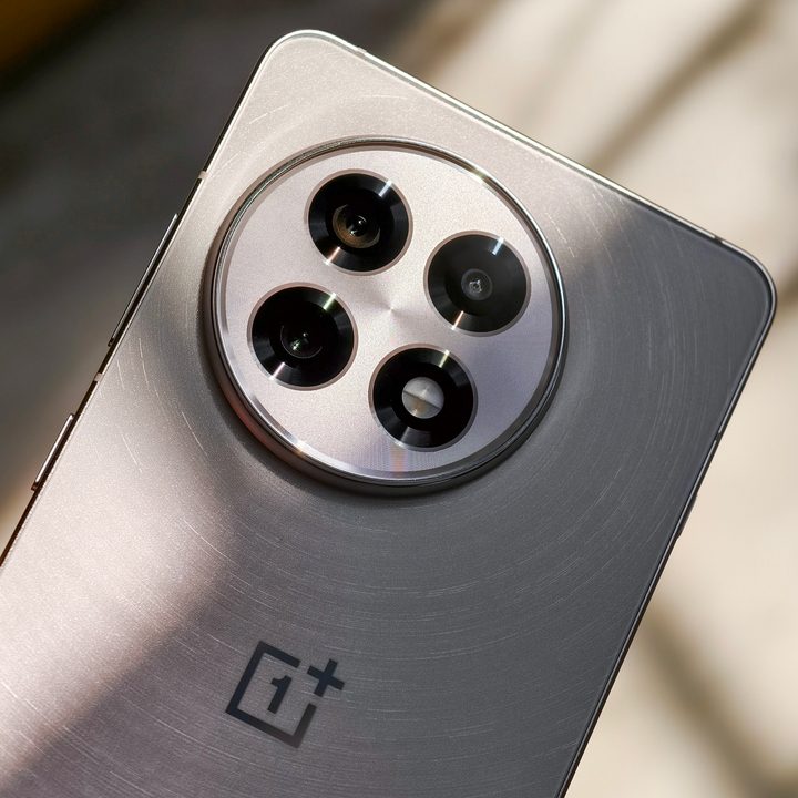 Camera module on the OnePlus 13R white held in hand.