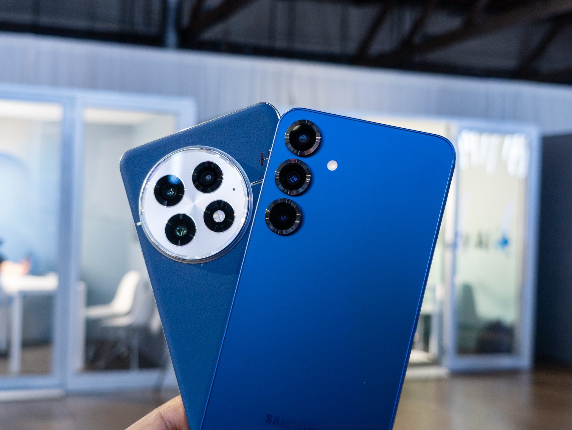The Galaxy S25 Plus in Navy vs the OnePlus 13 in Blue