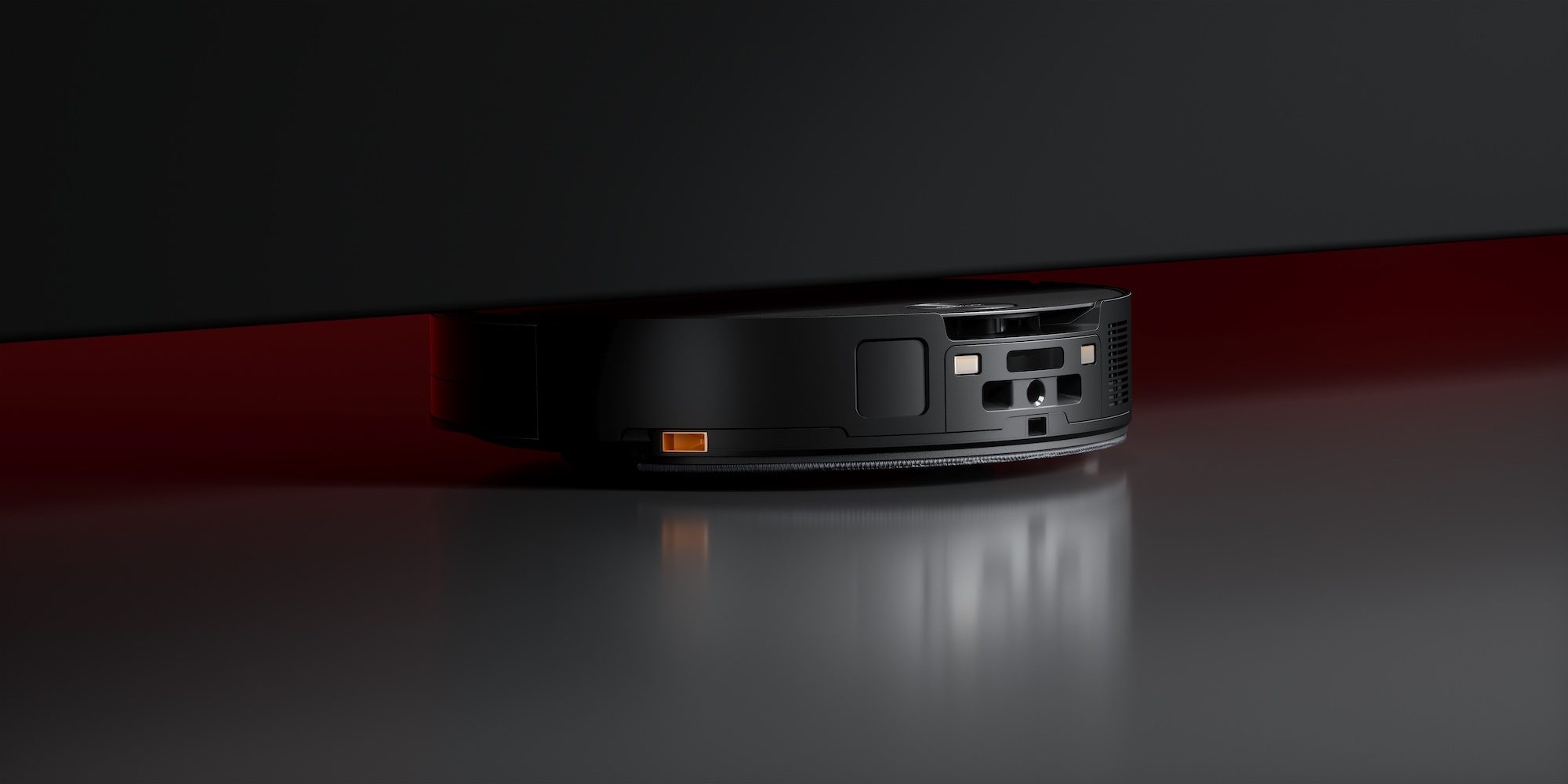 The Roborock Saros 10 navigating under a tight, low-clearance piece of furniture.