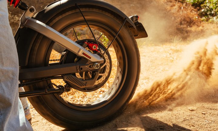 Segway Xyber e-Bike kicking up sand in the dirt.