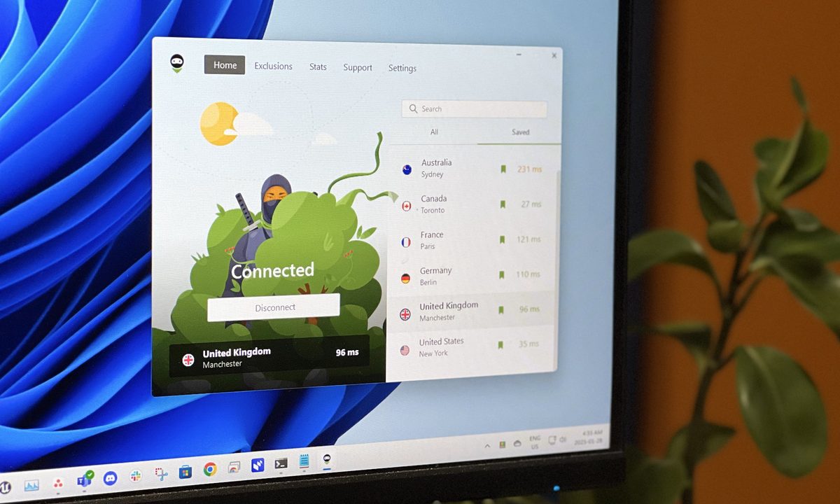 The AdGuard VPN app is open on a PC monitor.