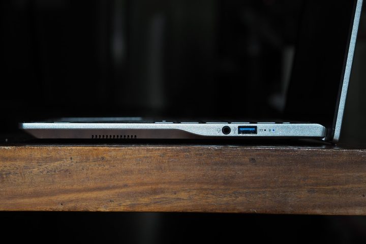 Acer Swift 14 AI AMD side view showing ports and lid.