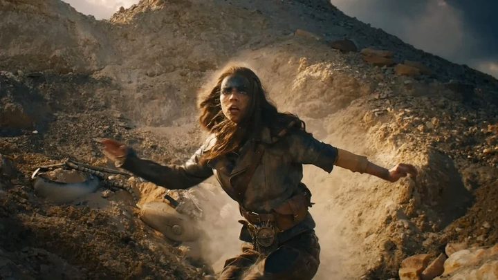 Furiosa descends a hill in Furiosa: A Mad Max Tale.