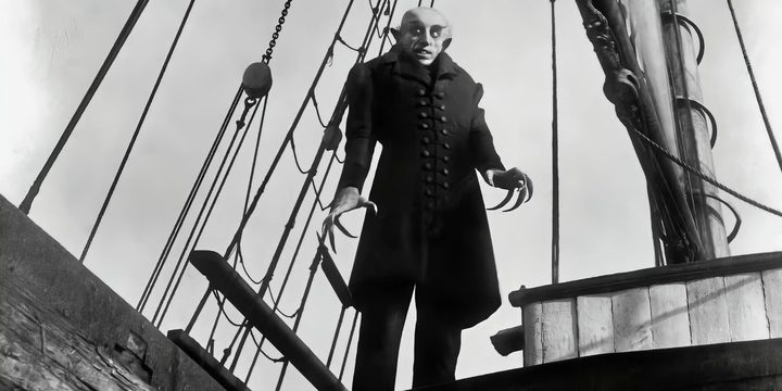 A vampire stands on a ship in Nosferatu.