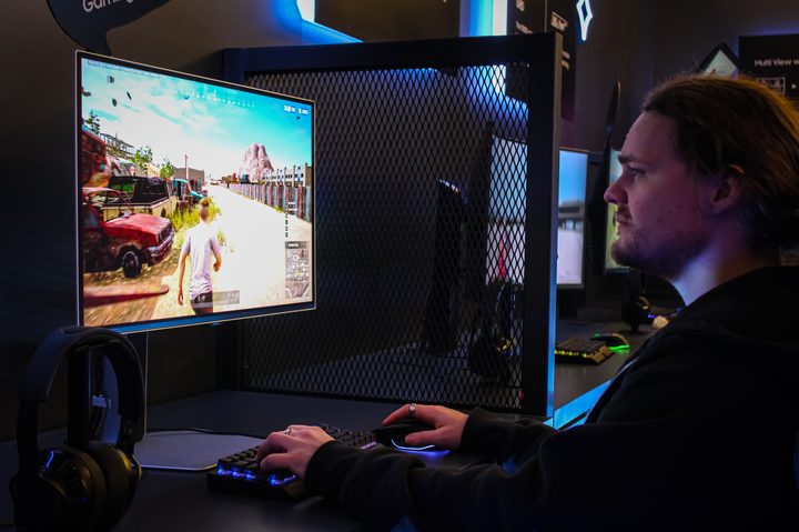 Someone playing the Samsung Odyssey OLED G6 gaming monitor.