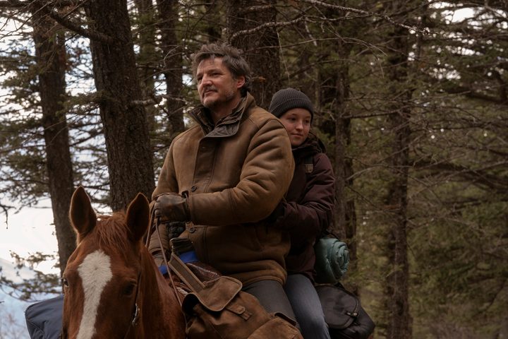 Joel rides on a horse with Ellie in The Last of Us.
