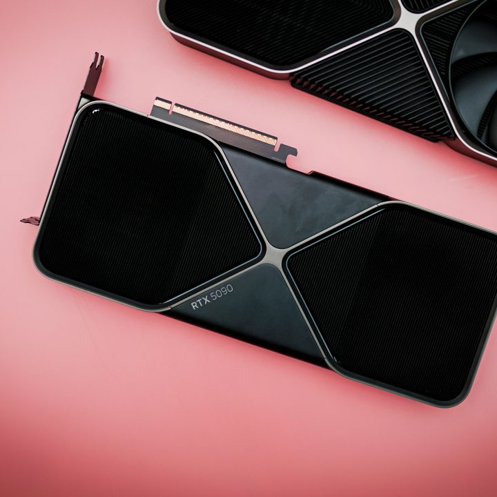 The RTX 5090 sitting on a pink background.