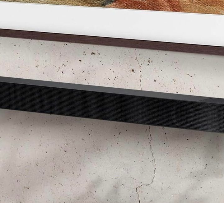 The Samsung HW-S800D Soundbar mounted below a wall-mounted TV.