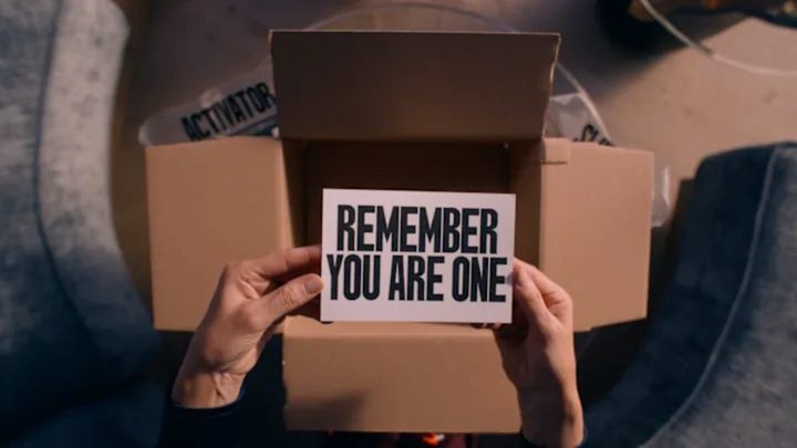A woman holds a letter in The Substance.