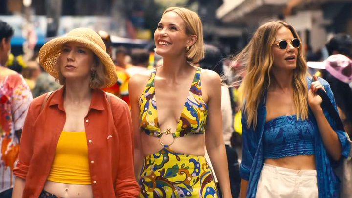 Three ladies dressed for summer walking in The White Lotus season 3.