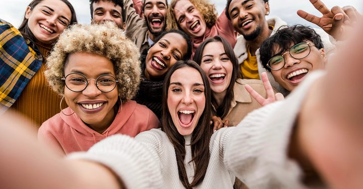 diverse group of people taking a selfie