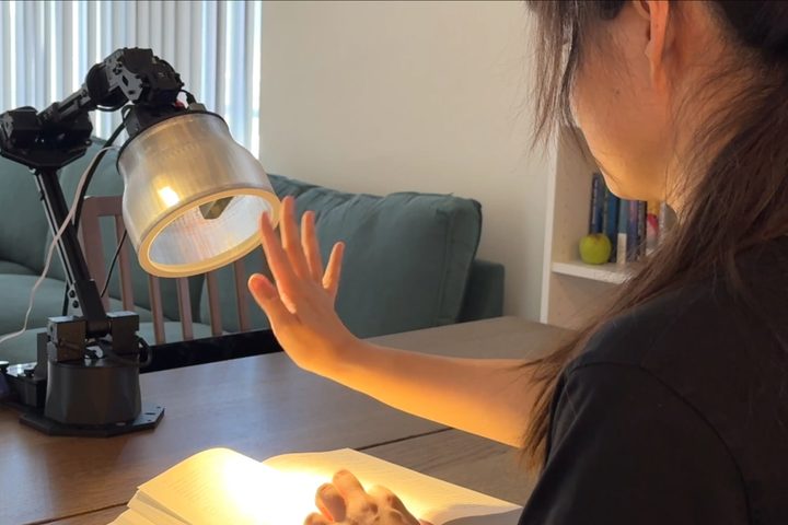 A researcher with Apple's Pixar-like robotic lamp prototype.