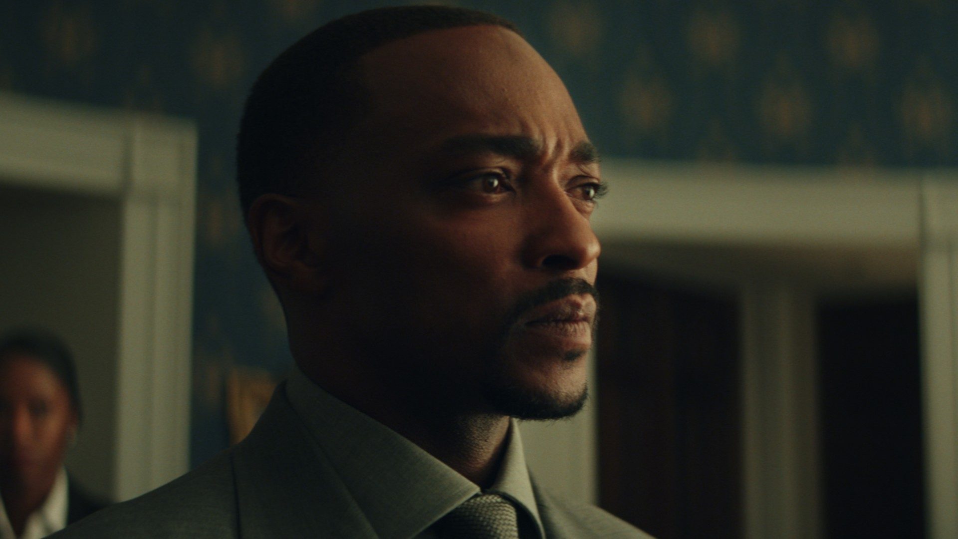 Anthony Mackie looks concerned in a close-up image from the movie Captain America: Brave New World.