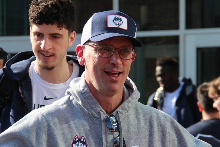 Danny Hurley holds his arms out and smiles.