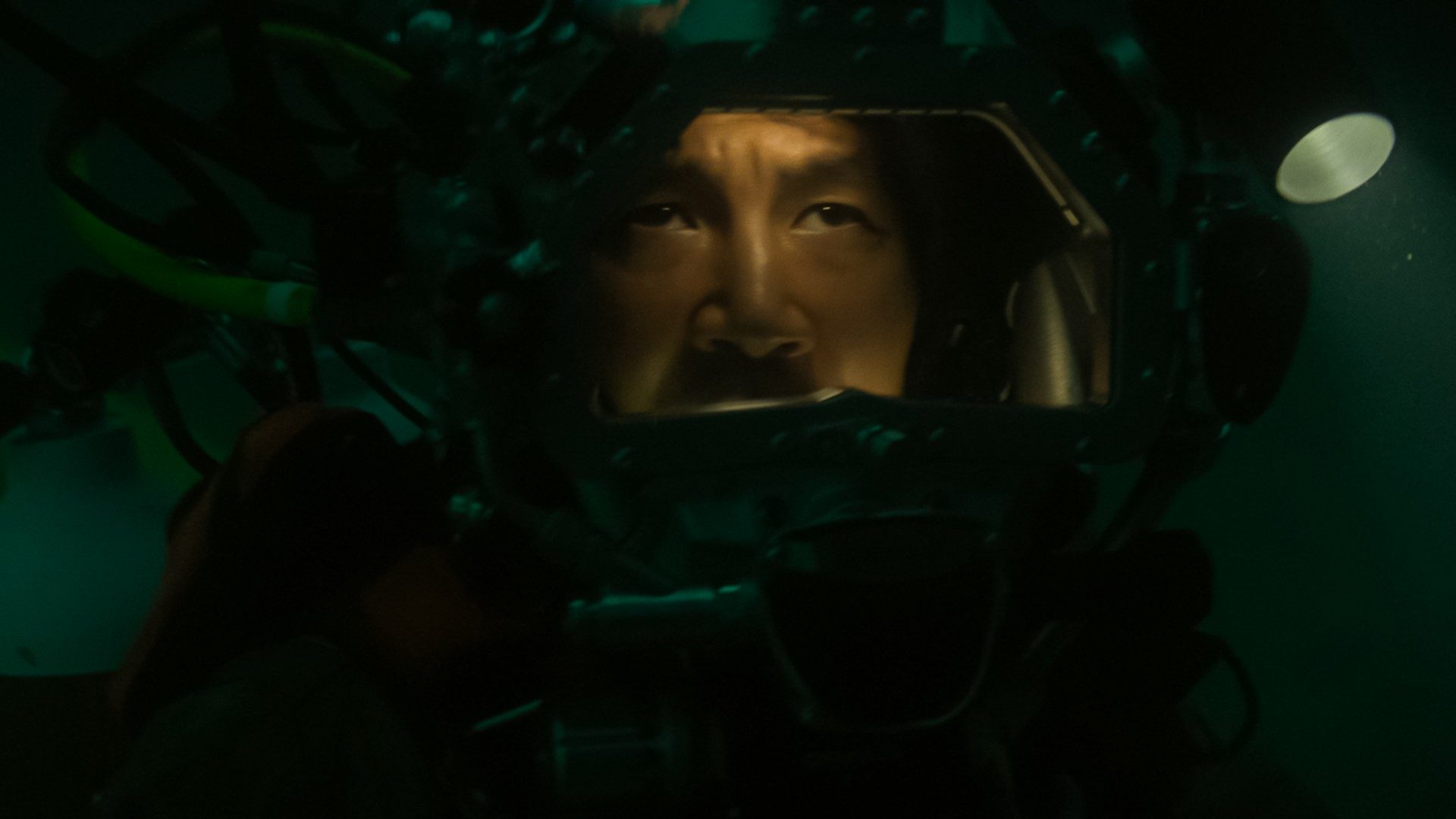 Simu Liu stares from inside a diving helmet in a still from the movie Last Breath.