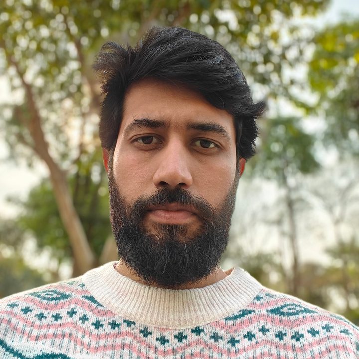 Daytime portrait selfie of a man shot with OnePlus 13R.