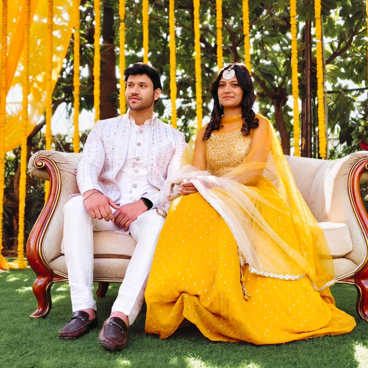 Portrait of an Indian bride and groom sitting for the wedding ceremony shot on Vivo V50 with Zeiss effects and Aura Light.