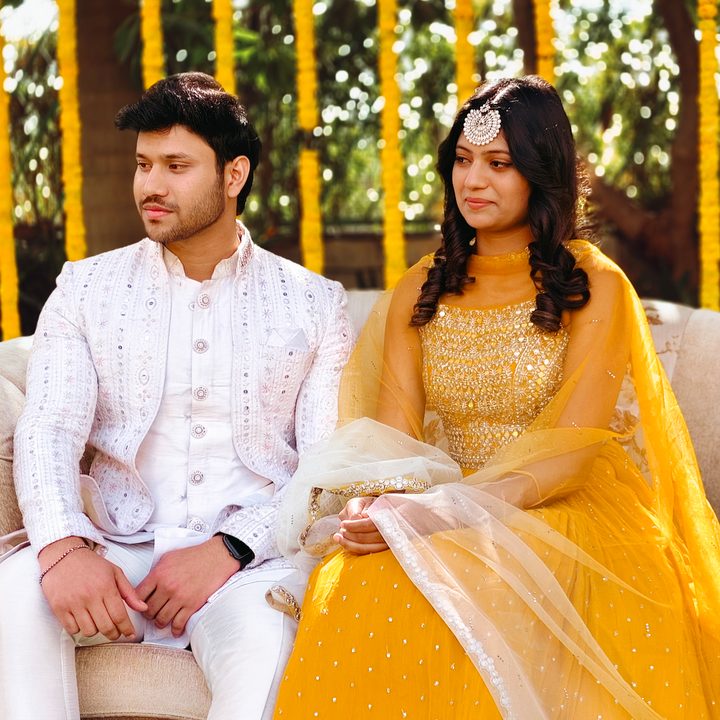 Portrait of an Indian bride and groom sitting for the wedding ceremony shot on Vivo V50 with Zeiss effects and Aura Light.