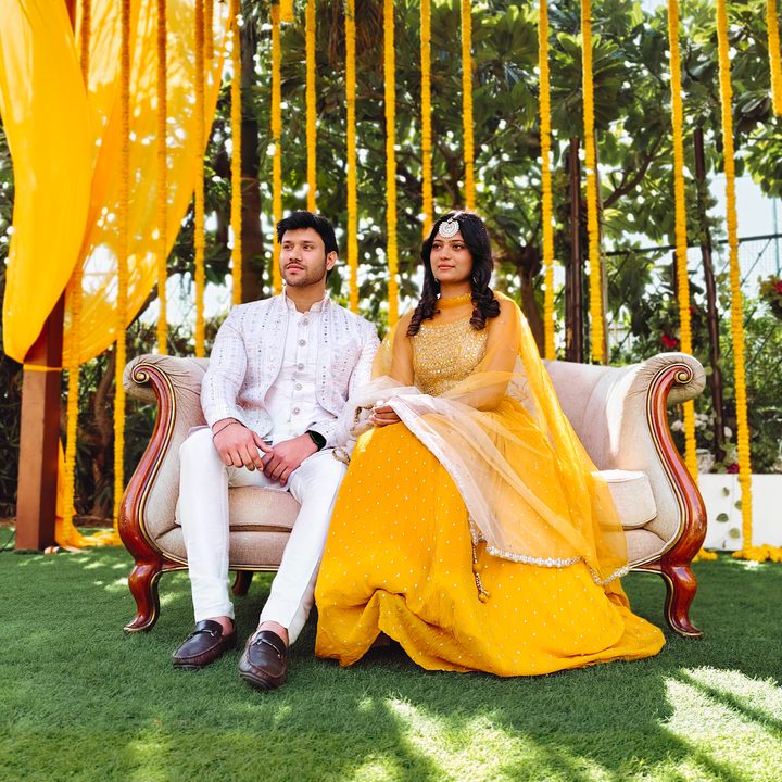 Portrait of an Indian bride and groom sitting for the wedding ceremony shot on Vivo V50 with Zeiss effects and Aura Light.