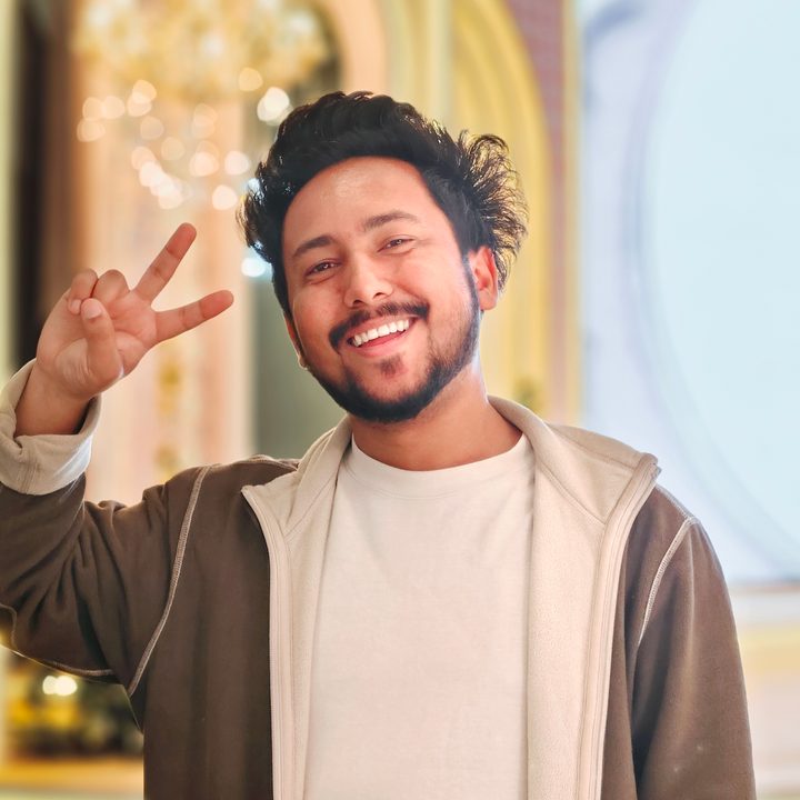 Portrait of a man standing in front of a bright stage setting shot on Vivo V50 with Zeiss effects and Aura Light.