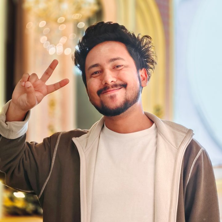 Portrait of a man standing in front of a bright stage setting shot on Vivo V50 with Zeiss effects and Aura Light.