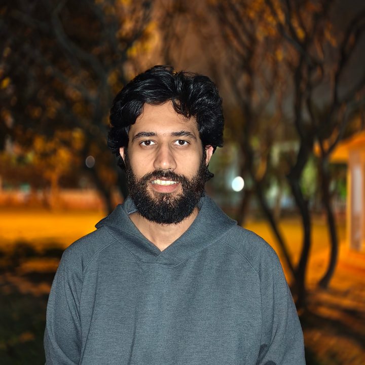 Portrait of a man standing in a park at night shot on Vivo V50 with Zeiss effects and Aura Light.