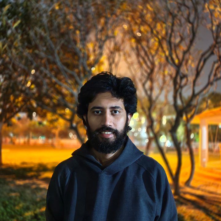 Portrait of a man standing in a park at night shot on Vivo V50 with Zeiss effects and Aura Light.