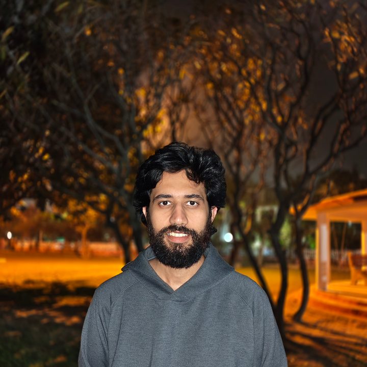 Portrait of a man standing in a park at night shot on Vivo V50 with Zeiss effects and Aura Light.
