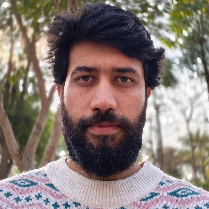 Daytime portrait selfie of a man shot with OnePlus 13R.