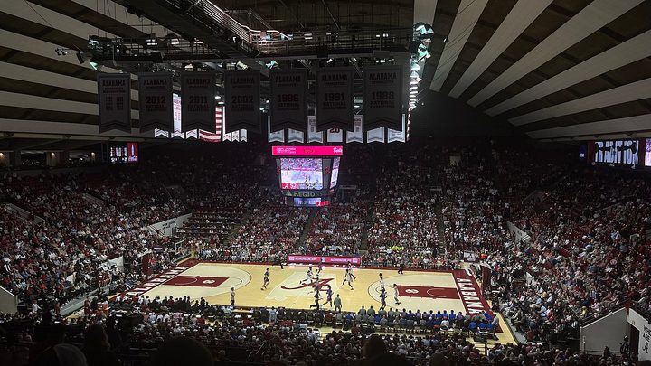 Fans watch the basketball game inside Coleman Coliseum.