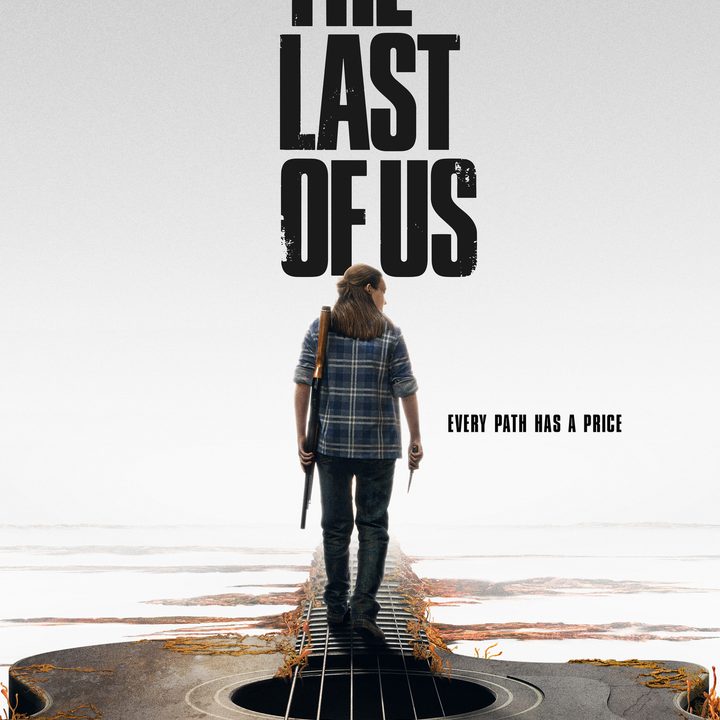 Bella Ramsey walks with a gun in The Last of Us.