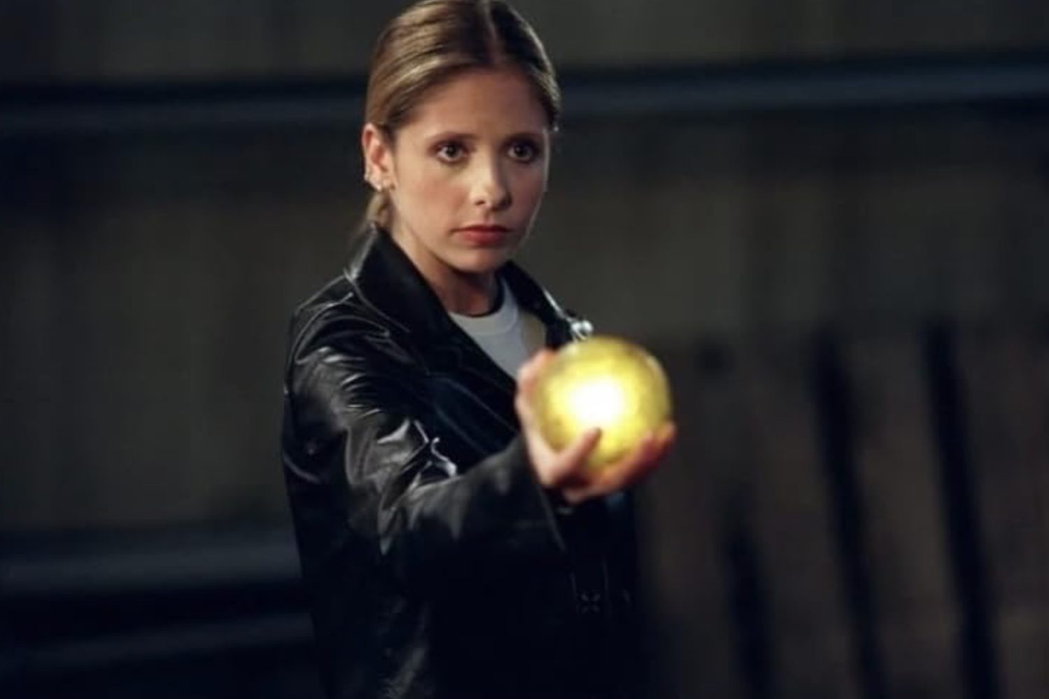 Buffy holds out a gold orb in Buffy the Vampire Slayer.