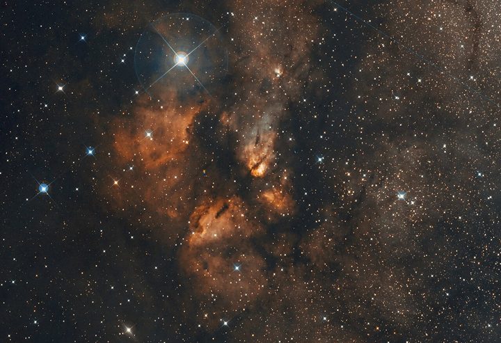 This image shows the RCW 38 stellar cluster in visible light. Dust absorbs most light at these wavelengths, hiding large areas of this cluster from us.