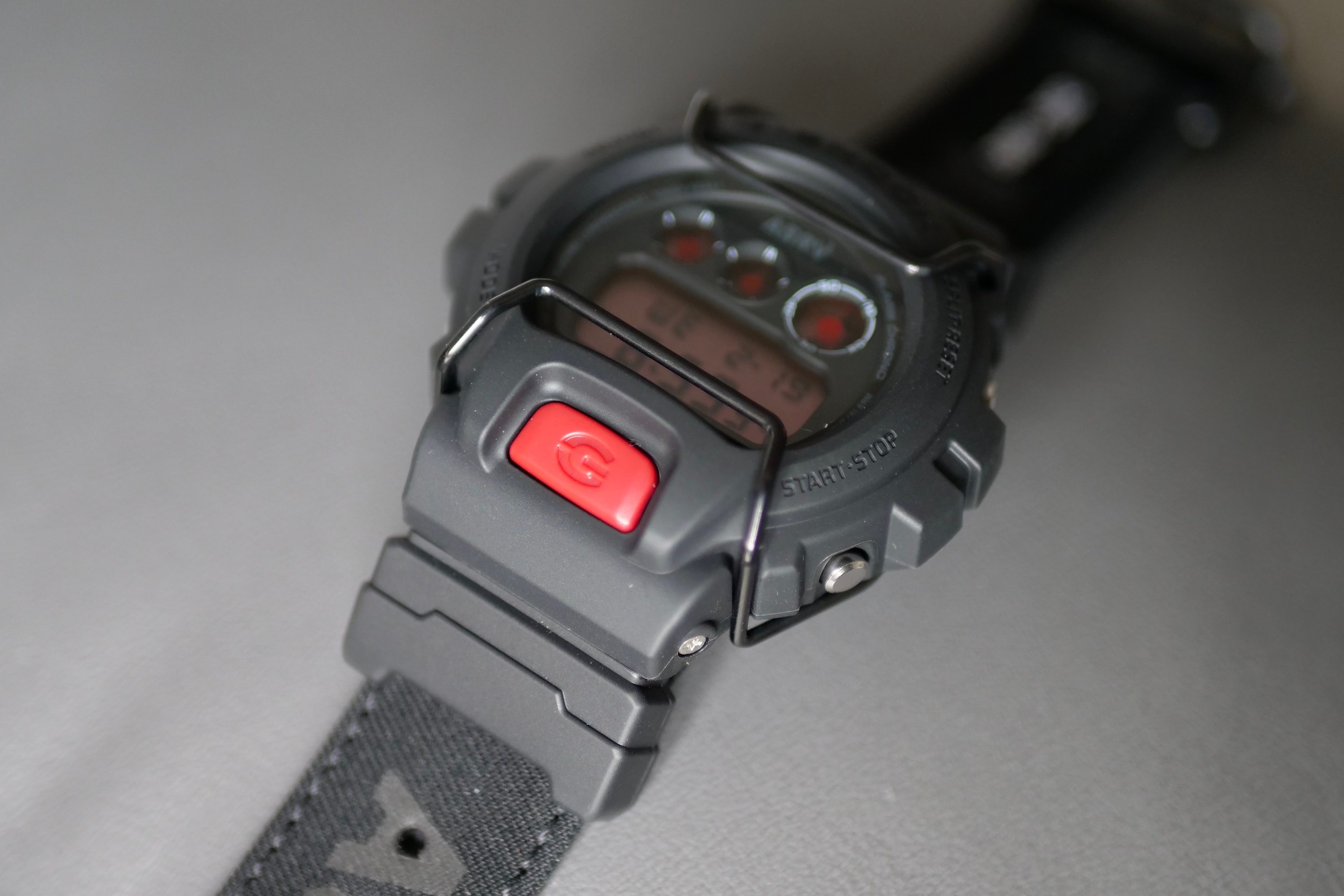 The G-Shock x ASRV DW-6900's backlight button.
