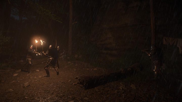 Characters holding torches at nighttime.