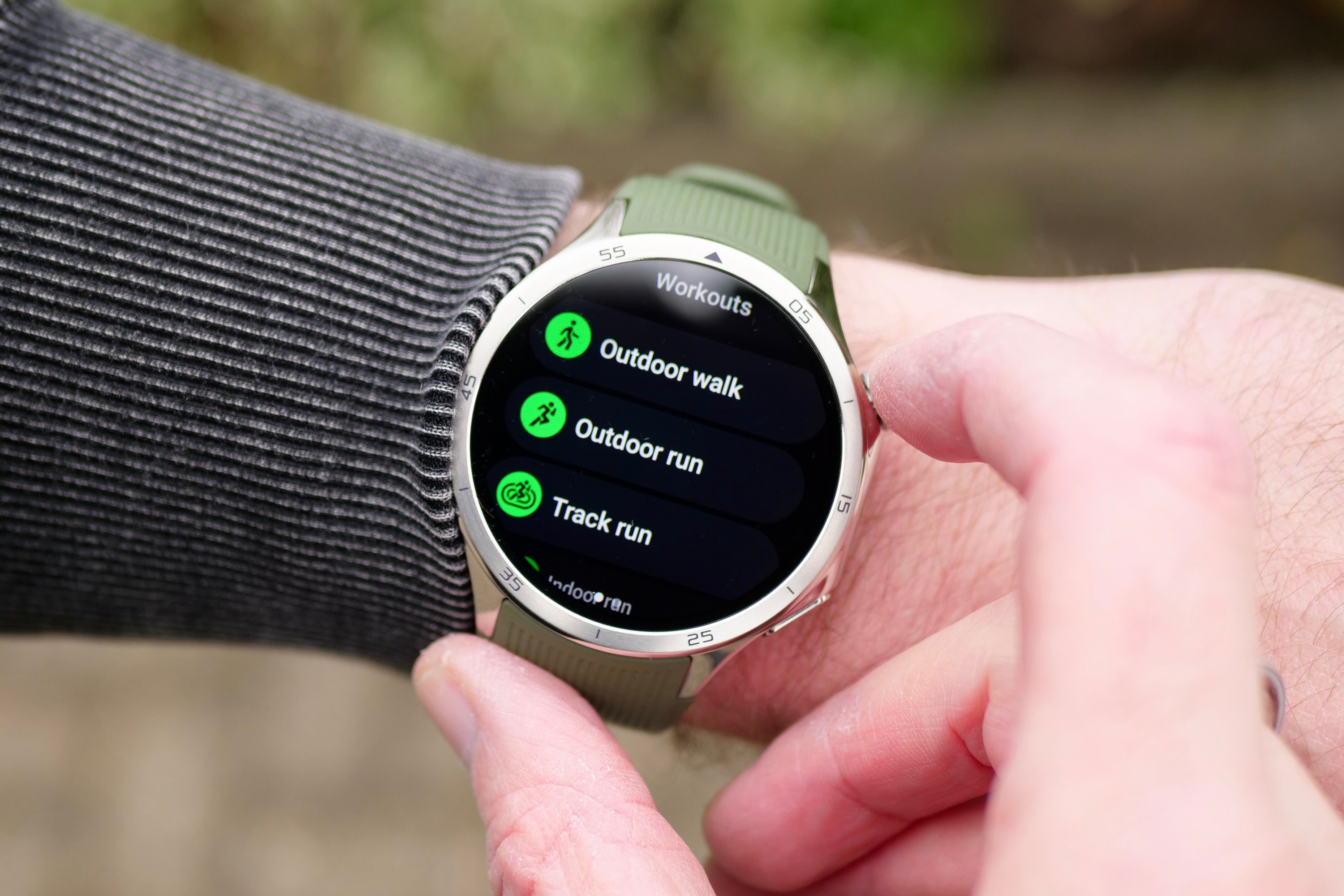 A person wearing the OnePlus Watch 3 showing the different activities available.