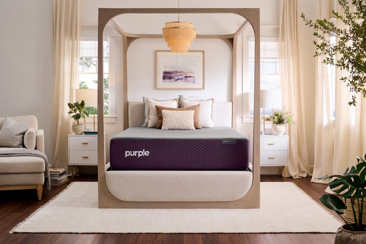 Purple Restore Premier mattress in a four poster bedframe.