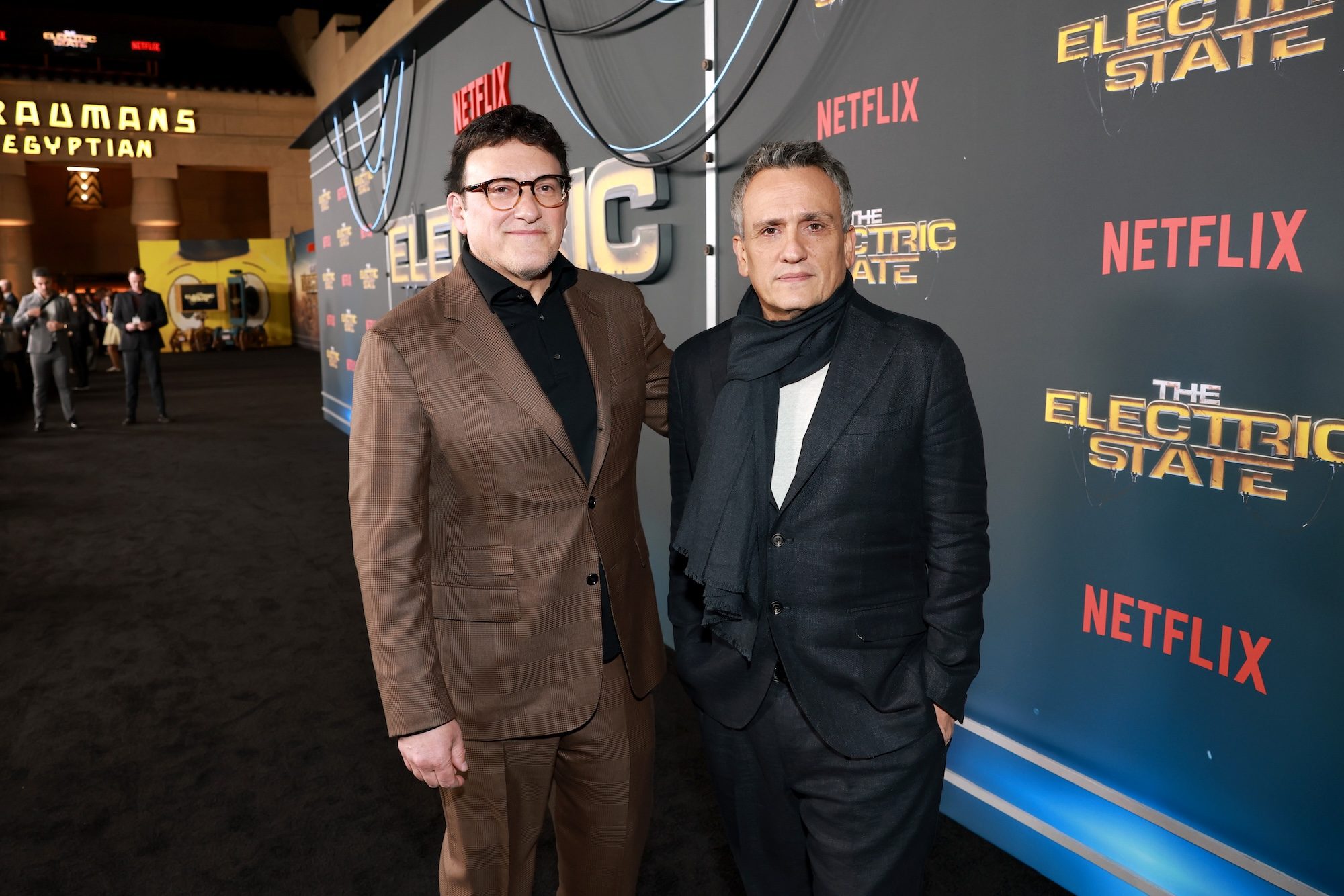 The Russo Brothers pose for a photo on the red carpet at the world premiere of The Electric State.