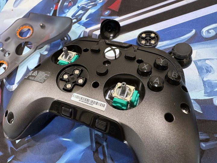 A Scuf Valor Pro sits on a table with its parts removed.