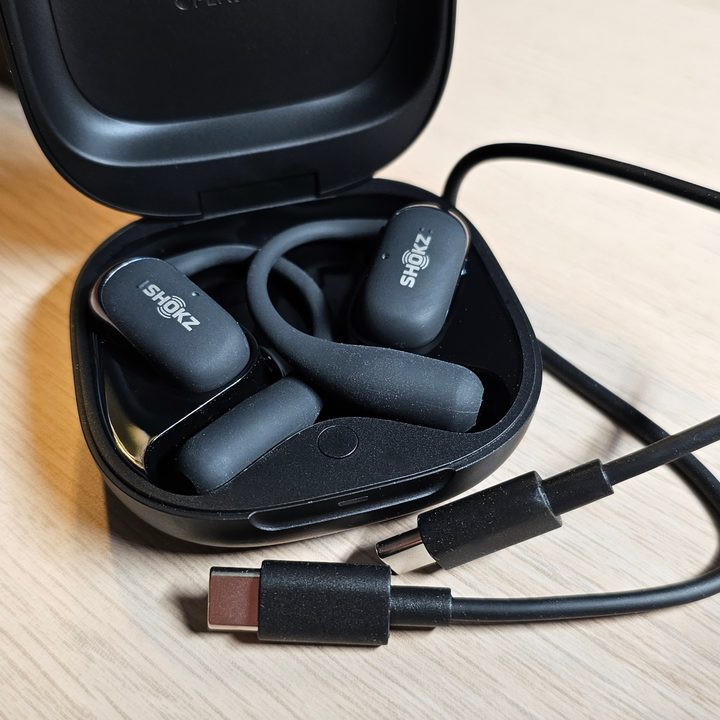 Shokz OpenFit 2 with charging cable.