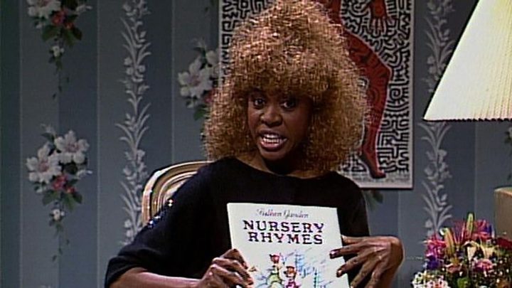 Danitra Vance on SNL holding up a book of nursery rhymes.