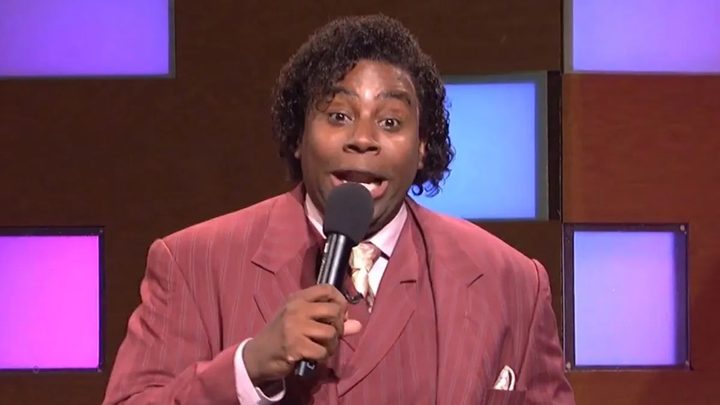 Kenan Thompson with a jerry curl wig and a mic in SNL.