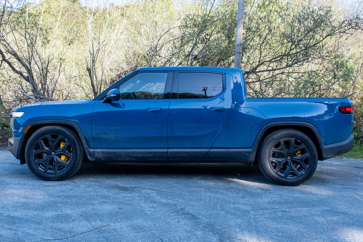 The side of a blue 2025 Rivian R1T truck