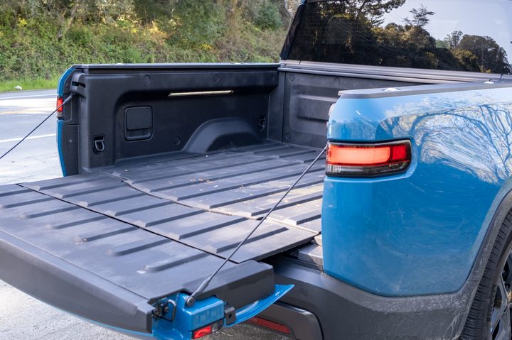 The truck bed of a blue 2025 Rivian R1T truck