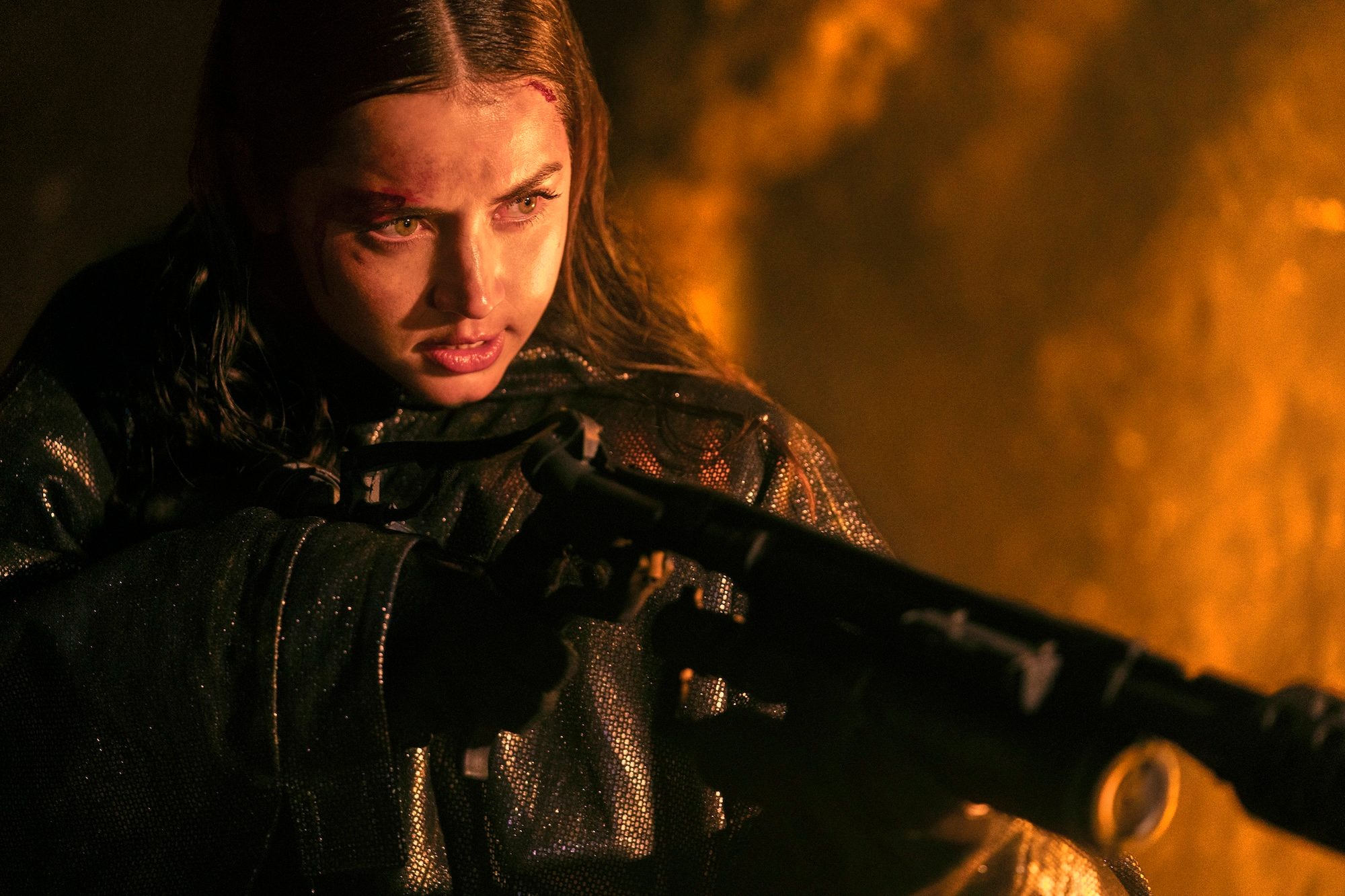 Ana de Armas wields a gun and points it in Ballerina.