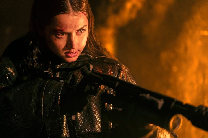 Ana de Armas wields a gun and points it in Ballerina.